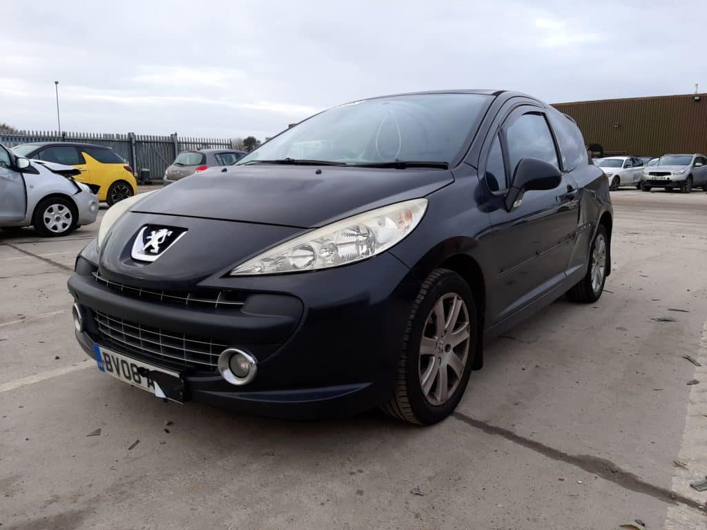 Front view of a parked black Peugeot 207